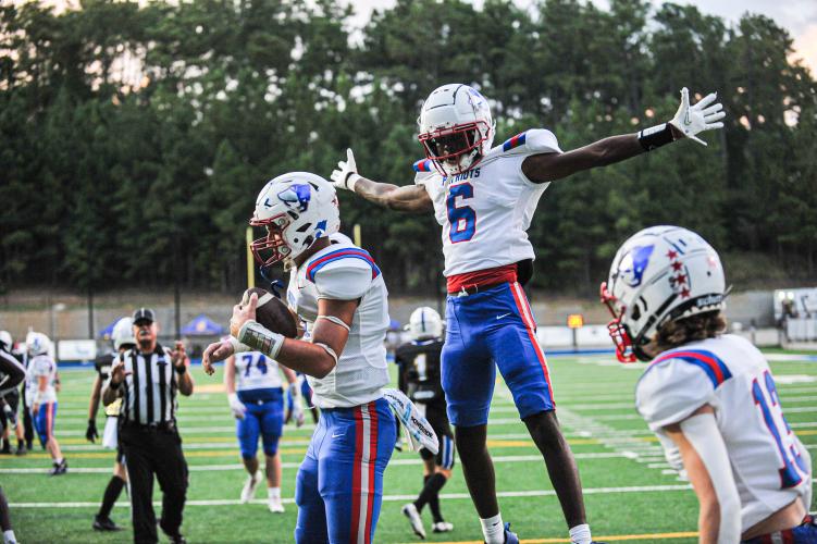 Darius Heard (No. 6) enjoys the moment after Jake Turner (left) scores a touchdown in Oglethorpe County's 20-7 victory over Lake Oconee Academy last Friday. The Patriots host Greene County at 7:30 p.m. Friday night. (CHARLES JORDAN/FOR THE OGLETHORPE ECHO)