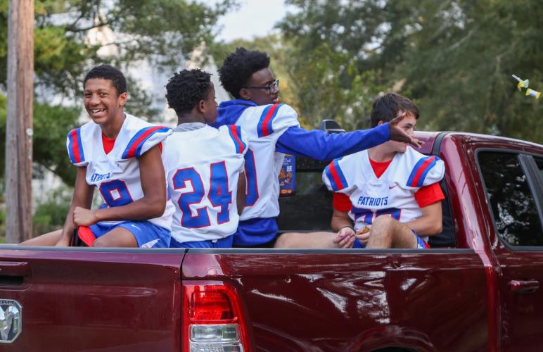Members of the Oglethorpe County High School football team ride in the back of a truck during the homecoming parade. (Photo/Cassidy Hettesheimer)