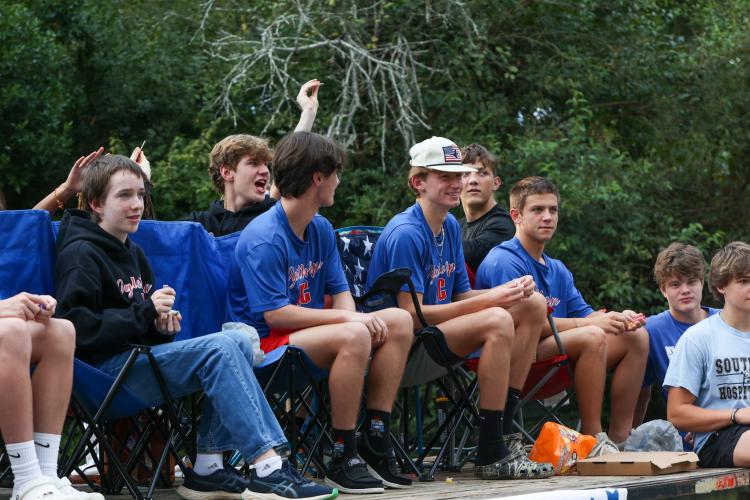 The Oglethorpe County High School cross country team tosses candy to onlookers during the county homecoming parade on Thursday, Sept. 21, 2023. (Photo/Cassidy Hettesheimer)