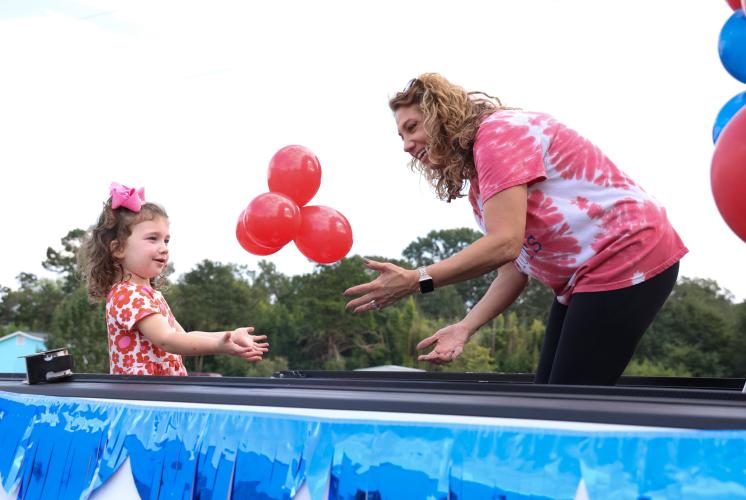 Diane Poulnott and niece Ramsey Little add balloons to a truck float for the Oglethorpe County High School homecoming parade on Thursday, Sept. 21, in Crawford, Georgia. (Photo/Cassidy Hettesheimer)