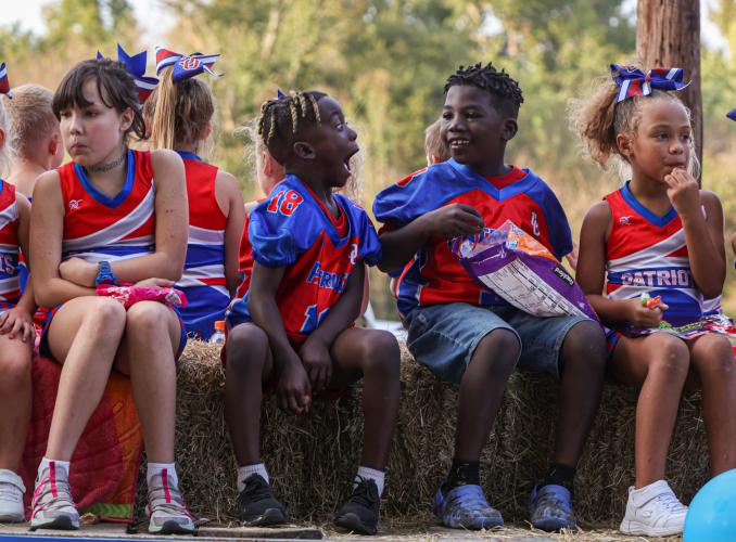 Members of the 6U Patriots football and cheer teams, including Wyatt Hackney and Alexander Harper, turn into Bryan Park to end the homecoming parade, which included floats from youth sports teams, in addition to Oglethorpe High School teams. (Photo/Cassidy Hettesheimer)