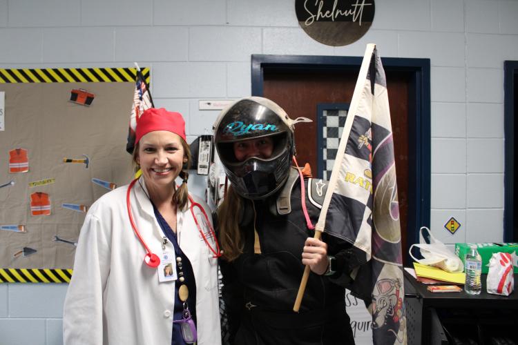 Kim Smith (left) wears a doctor theme while Monique Shelnutt's (right) wears her race car themed outfit. The two teachers got in costume to match their room decorations for the event. (Photo/Caleb Baldwin)