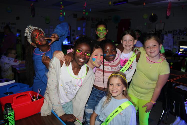 Katie Bailey’s fifth grade class were excited to have music and glow in the dark colors around the room. Fifth graders, Caroline Wilson, Ansley Ruzowicz, Samantha Ramirez, Misha Wilson, Kadence Westemorland and Kaylyn Carrch described the day as “fun” and preferred doing their classwork in a glow theme. (Photo/Caleb Baldwin)