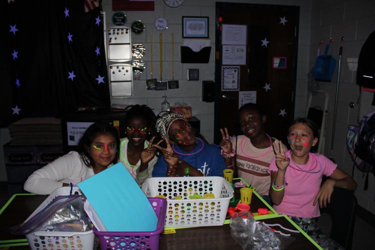Katie Bailey’s fifth grade class were excited to have music and glow in the dark colors around the room. Fifth graders, Caroline Wilson, Ansley Ruzowicz, Samantha Ramirez, Misha Wilson, Kadence Westemorland and Kaylyn Carrch described the day as “fun” and preferred doing their classwork in a glow theme. (Photo/Caleb Baldwin)