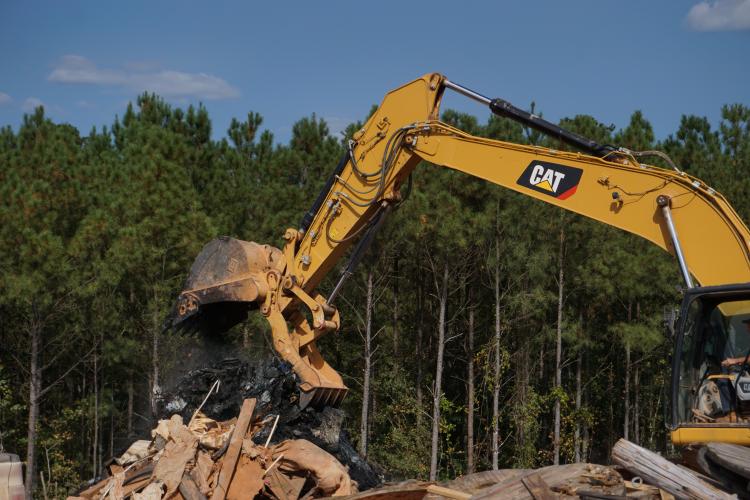 An excavator dumps a load of debris at the Oglethorpe County Construction and Demolition Landfill earlier this week. (Photo/Jay Reece)