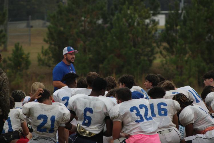 Oglethorpe County head coach Michael Holland speaks to his players after a recent practice. The Patriots will play host to Prince Avenue, the defending Class A Division I state champion, at 7:30 p.m. Friday. (LAUREN HILL/THE OGLETHORPE ECHO)