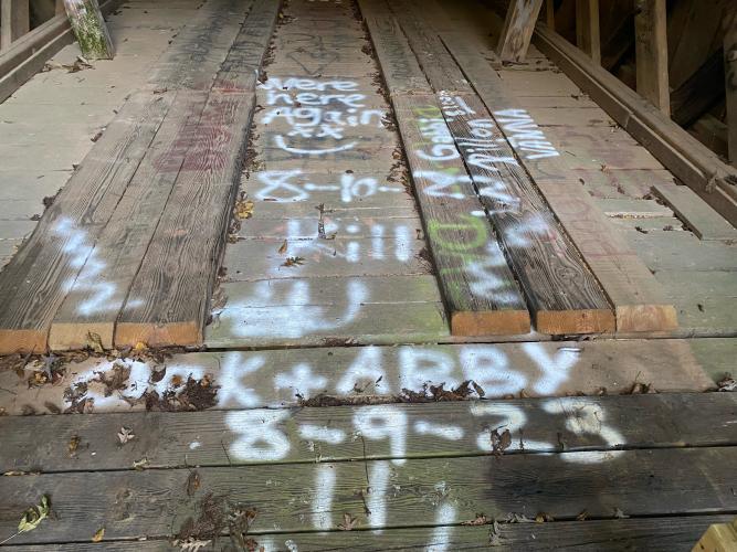 Graffiti covers the recently repaired Howard’s Covered Bridge, which was built in 1904-05. (Submitted Photo)