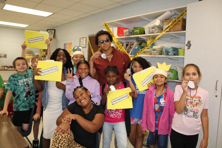 ohn Lutz’s art room was turned into a crime scene for Rock Your School day. The class used their art skills to color suspects and use confidential files to identify the criminal. (Photo/Caleb Baldwin)