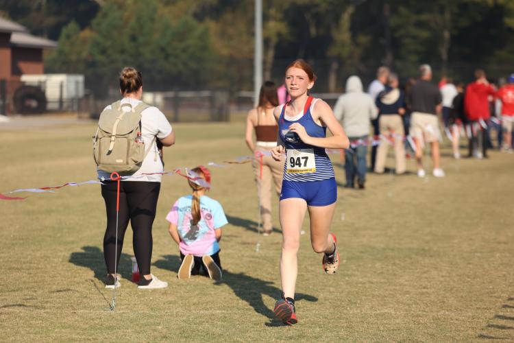 Mylee Nimmons sprints toward the finish line in the varsity girls region 5K in Social Circle, Georgia, on Tuesday, Oct. 24, 2023. Nimmons placed fifth overall with a time of 23:18. (Photo/Cassidy Hettesheimer)
