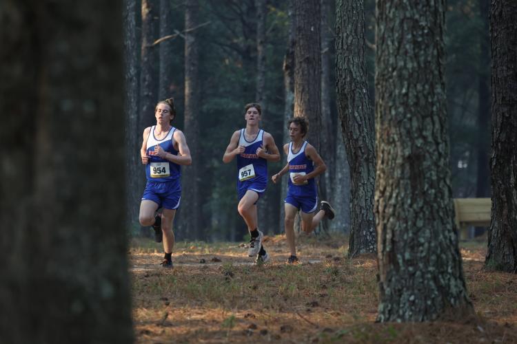 Oglethorpe County senior Logan Grier, sophomore Ethan McLean and sophomore Cory Tillman run through the woods during the varsity boys 5K at the region cross country meet hosted in Social Circle, Georgia, on Tuesday, Oct. 24, 2023. The Patriots placed first out of four teams in the varsity boys 5K. (Photo/Cassidy Hettesheimer)