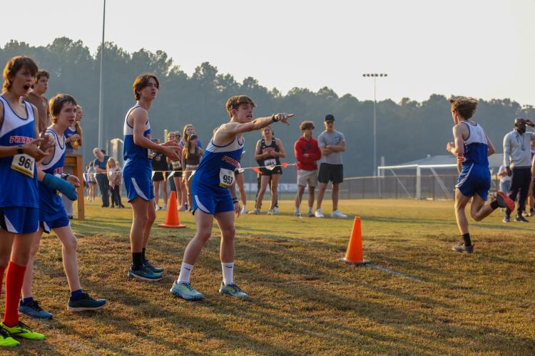 Members of the Oglethorpe County junior varsity boys cross country team cheer on the Patriots finishers in the varsity race at the 1A Division 1 Region 5 meet in Social Circle, Georgia, on Tuesday, Oct. 24, 2023. (Photo/Cassidy Hettesheimer)