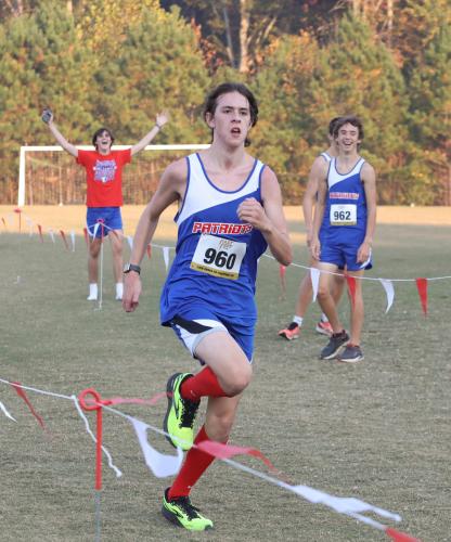 Nathen Reesman sprints to the finish of the junior varsity 5K at the Region 5-A Division 1 cross country meet in Social Circle. His teammates cheered him on along the final stretch. (Photo/Cassidy Hettesheimer)Nathen Reesman sprints to the finish of the junior varsity 5K at the Region 5-A Division 1 cross country meet in Social Circle. His teammates cheered him on along the final stretch. (Photo/Cassidy Hettesheimer)