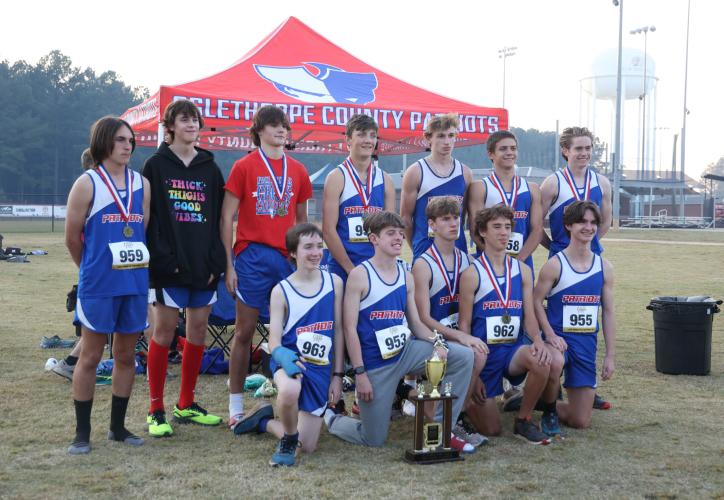 The Oglethorpe County boys cross country team poses for a photo with its first-place region trophy in Social Circle, Georgia, on Tuesday, Oct. 24, 2023. The Patriots placed first of four teams in the varsity boys 5K, with the team's first five runners finishing in the top 10. (Photo/Cassidy Hettesheimer)