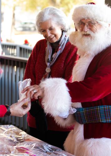 Mrs. Claus and Santa (Donna and Jim Anderson) purchase homemade fudge at the Christmas Market in Crawford on Sunday, Nov. 21, 2021. Jim Anderson said he has appeared as Santa Claus at the Crawford Christmas Market every year it's been held for almost a decade. (Submitted Photo)