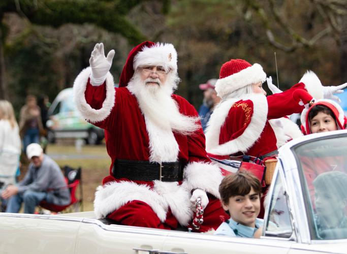 Santa, who is a guest of honor at the Maxeys Christmas Parade, waves from his float in a recent parade. This is the fifth year for the parade, which also includes vendors, musical groups and food trucks.