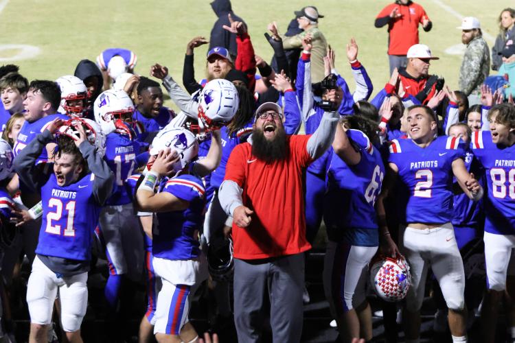 Offensive line coach Josh Austin and several players enjoy the moments after Oglethorpe County's last second 35-28 victory over Jasper County on Friday. The Patriots clinched the third seed from Region 5-A Division and will play at Elbert County in the first round of the state playoffs at 7:30 p.m. Friday. The Blue Devils are 8-2 and are the No. 2 team from the region 8-A Division 1. (Diana Lopez Garcia/The Oglethorpe Echo)