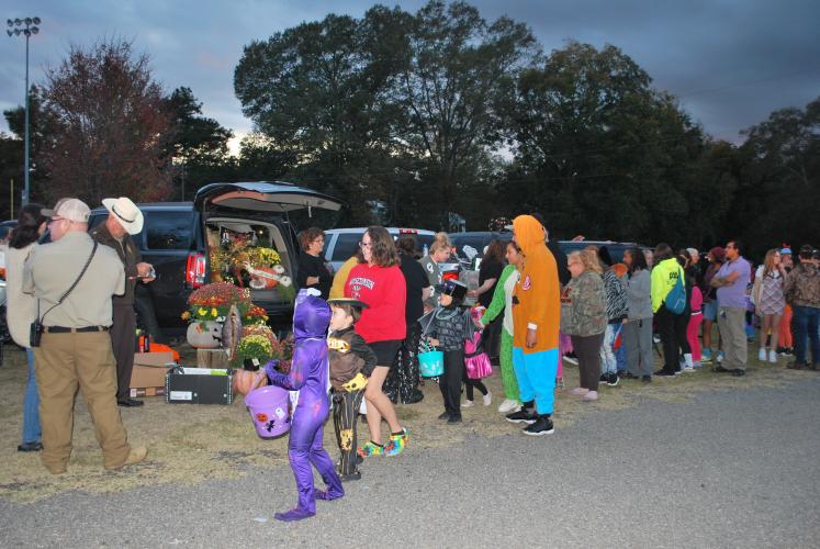 Oglethorpe County residents line up along the line of decorated trunks and begin trick-or-treating. This is the county’s seventh year putting on the event.