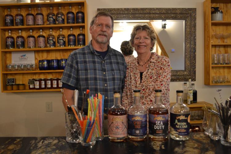 Mark Davis, a retired Marine, and Jennifer Berry, owners of Soldier of the Sea Distillery in Comer, stand in the back of the distillery. Each product used in the process is made in the U.S. and a majority are locally/regionally sourced. Grace Mains/The Oglethorpe Echo