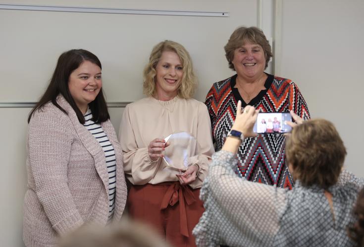 Oglethorpe County School System superintendent Beverley Levine and board chair Becky Soto present kindergarten teacher Shonda Cronic with the Oglethorpe County system-wide Teacher of the Year award at the board of education meeting in Lexington, Georgia, on Tuesday, Nov. 7, 2023. Cronic is also an alum of Oglethorpe County Schools. (Photo/Cassidy Hettesheimer)