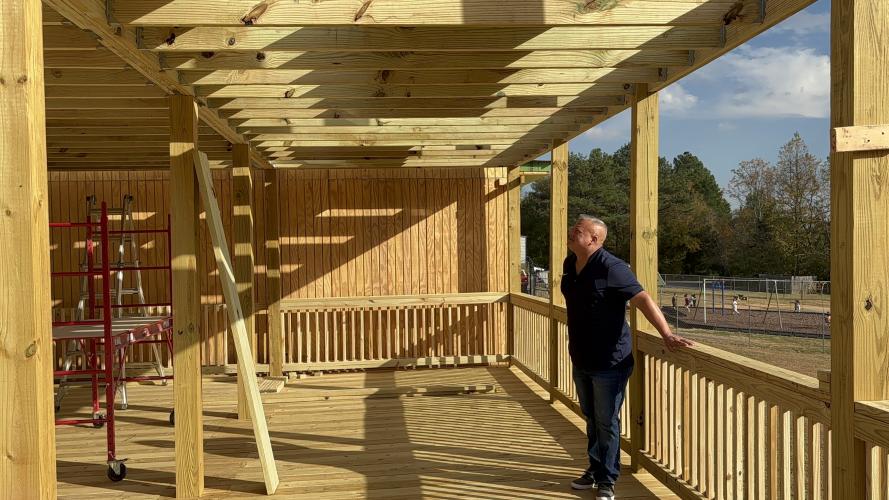 Co-owner, Josh Robayo, stands under the second level porch to take a look at the future Kafe. Robayo and his family began this project two years ago when looking for the perfect spot to start their business. (Grace Mains/The Oglethorpe Echo)