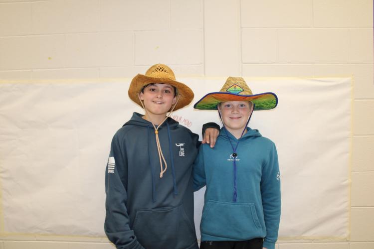 Seventh graders, Remington Boswell (left) and Grayson Brewer pose together with matching straw hats and blue hoodies for the theme. (Photo/Caleb Baldwin)