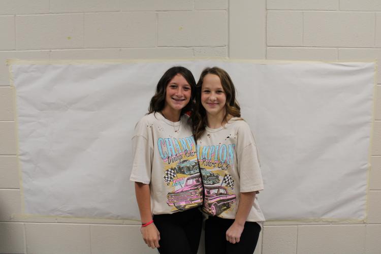 Mackenzie Erwin (left) and Abby Morris match shirts for the seventh graders’ twin day. (Photo/Caleb Baldwin)