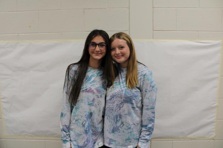 Seventh graders, Arrington Clark (left) and Janessa Reesman twinned in matching blue, white and purple shirts for twin day. (Photo/Caleb Baldwin)