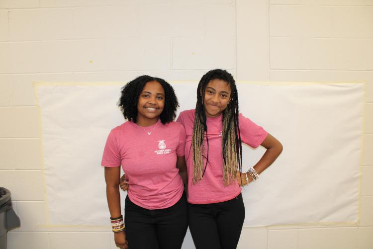 Seventh graders, Shanice Brown (left) and Armonie Gresham pose for twin day. They matched with school spirit in Oglethorpe County Middle School shirts. (Photo/Caleb Baldwin)