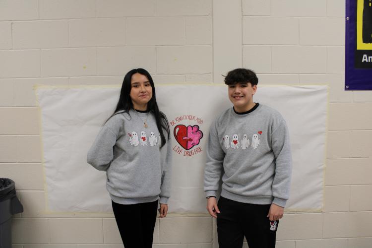 Camila Montez (left) and Dakota Chandler pose in matching sweatshirts. Their Halloween spirit showed through the sweatshirts with cartoon ghosts on them. (Photo/Caleb Baldwin)
