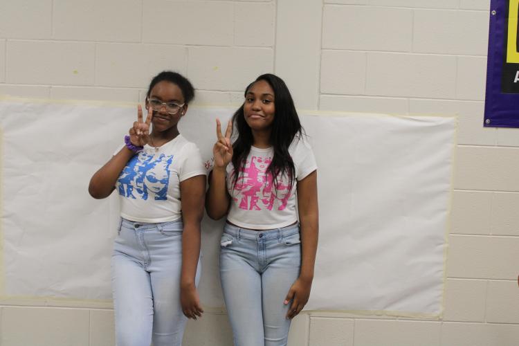 Kamira Appling and Sariyah Huff pose in matching shirts. The two eighth graders twinned with shirts of different colors. (Photo/Caleb Baldwin)