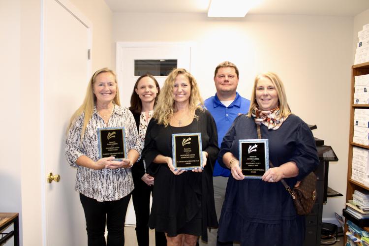 The 2023-2024 classified employees of the year: Kathi Matthews, OCPS nurse; Toni Evans, OCES special education paraprofessional; Saundra Gabriel, OCMS nurse and cheer coach. Behind them are principals of Oglethorpe Schools (left to right): Katie Baldwin, primary and elementary schools; Mack Baldwin, middle school. Also a classified employee of the year, Meredith Meyer, OCHS secretary, was not present for the recognition ceremony.(Photo/Caleb Baldwin)