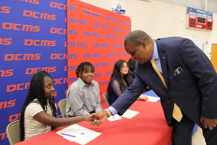 Guest speaker, Otha Thornton, shakes the hand or REACH scholar, Jimmyka Gresham. Thornton told the five students to strive for excellence and set and accomplish goals throughout life to find success. (Caleb Baldwin/The Oglethorpe Echo)