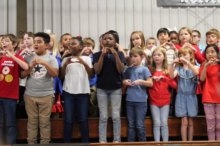 Second graders sang "Yankee Doodle" among the seven songs they performed. The students were split into groups of two for singing songs in turns until all singing "God Bless the USA" together. (Caleb Baldwin/The Oglethorpe Echo)