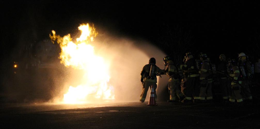 During the live training, the initial flames can shoot up to 40-50 feet in the air. Once the flames die down, firefighters advance toward the tank until the fire is entirely covered. They then continue to cool down the tank and prepare for the next fire.