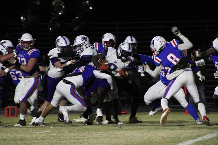 Ashton Sexton (14) tackling Kaidon Whidby (0). The Patriots defeated the Hurricanes 35-28 on Friday, November 3. (Lauren Hill/The Oglethorpe Echo)