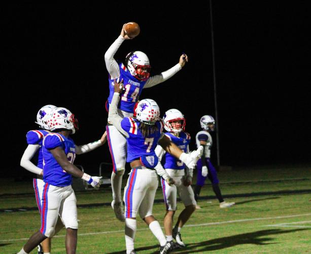 Ashton Sexton (14) gets lifted into the air by Keymon Pass (7) after scoring the game-winning touchdown to defeat Jasper County 35-28. Both players were honored before the game during the senior night ceremony. (Lauren Hill/The Oglethorpe Echo)