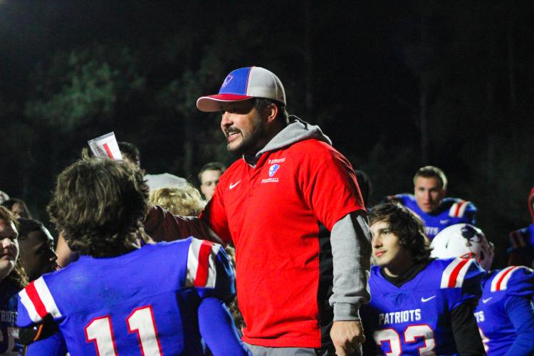 Head coach Michael Holland giving his team an after-game talk after their win over Jasper County. The Patriots beat the Hurricanes 35-28 on Friday, November 3. (Lauren Hill/The Oglethorpe Echo)