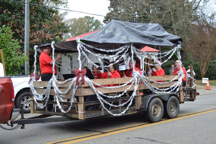 UGA Alumni Redcoat Band drove through playing a few Georgia fight songs and Christmas classics. The band intermediately yelled "beat bama" while playing in anticipation for Saturday's ballgame. (Grace Mains/The Oglethorpe Echo)