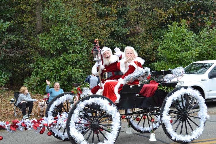 Santa Claus and Mrs. Claus wave and smile at the crowd during the fifth annual Maxeys Christmas Parade on Saturday. Children took photos and shared what they wanted for Christmas with Santa after the parade. (Grace Mains/The Oglethorpe Echo)