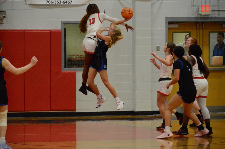 Kenzie Henderson blocks No. 22 Jill Daniel's shot at the basketball game against Oconee County on Jan. 6. Oglethorpe County girls won 53-43. (McCain Bracewell/The Oglethorpe Echo)