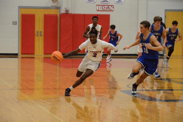 Jalien Lumpkin pushes upcourt with No. 10 Levi Slaten at the basketball game against Oconee County on Jan. 6. Oglethorpe County girls won 53-43 and the boys won 62-46. (McCain Bracewell/The Oglethorpe Echo)