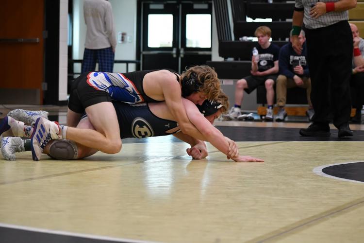 Rylee Clark gains the upper hand in his match against Elbert County in the semifinals of the area team duals. The Patriots defeated the Blue Devils 36-33 in the semifinals. (Wade Cheek/For the Oglethorpe Echo)