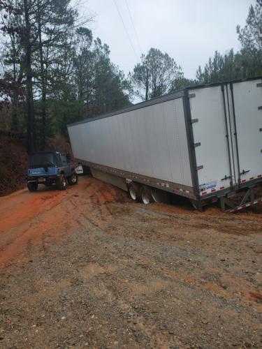 A tractor-trailer truck is stuck on a dirt road. Some parts of the county received more than 3 inches of rain on Monday night and Tuesday. (Submitted Photo)