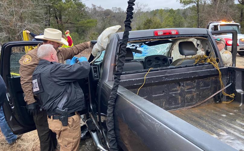 Oglethorpe County Sheriff David Gabriel (from left), Comer Police Department Chief Dennis Bell and Deputy Tommy Epps look for evidence in the pickup truck. Bell is a former investigator with the State Insurance Commission. (Submitted Photo)