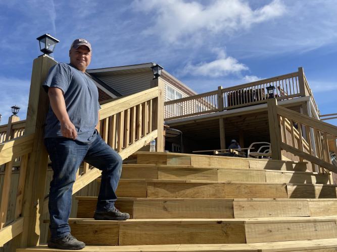 Josh Robayo, co-owner of Town and Country Kafe, stands on the grand staircase at the cafe and restaurant last week. (Margaux Binder/The Oglethorpe Echo)