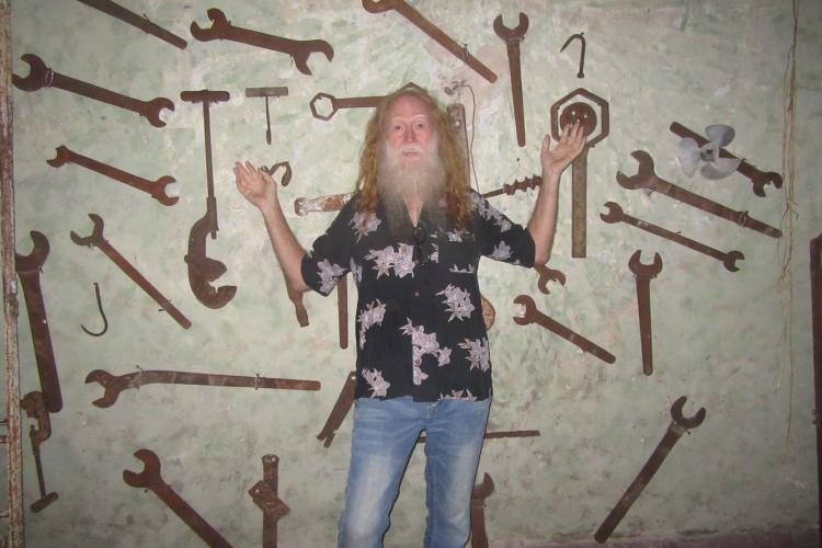 John Gingerich in front of a wall of rare items during his travels. (Submitted Photo)