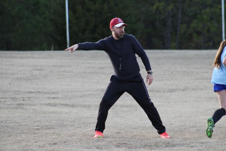 Girls head soccer coach Erich Forschler points to an open Patriot. This is Forschler's first season with the girls team after spending several seasons with the boys team. (Photo/Owen Warden)