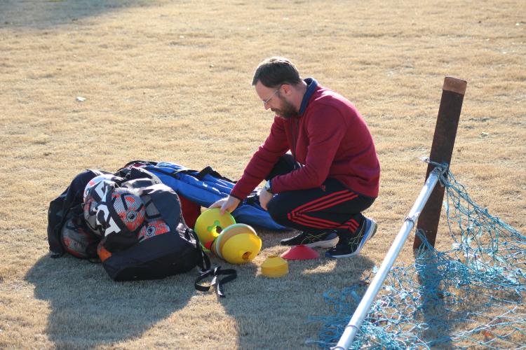 Erich Forschler grabs cones for soccer practice at the OCHS practice last week. (Samuel Higgs/The Oglethorpe Echo)