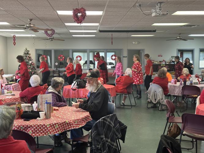Debbie Winsett leads a dance to the Cupid Shuffle by Cupid. She, and members of her line dance class, teach other volunteers the festive dance. (Lily Murphy/Oglethorpe Echo).