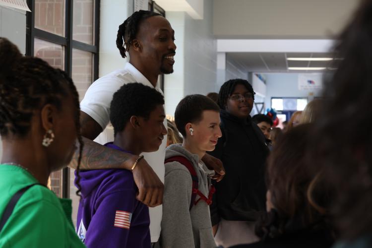 Dwight Howard Jr., who is 6-foot-10, hangs out with OCHS students before the start of the Patriot Promise, a new mentoring program started by Superintendent Beverley Levine. Howard played for the L.A. Lakers and Orlando Magic, among other teams. (Jim Bass/Oglethorpe Echo)